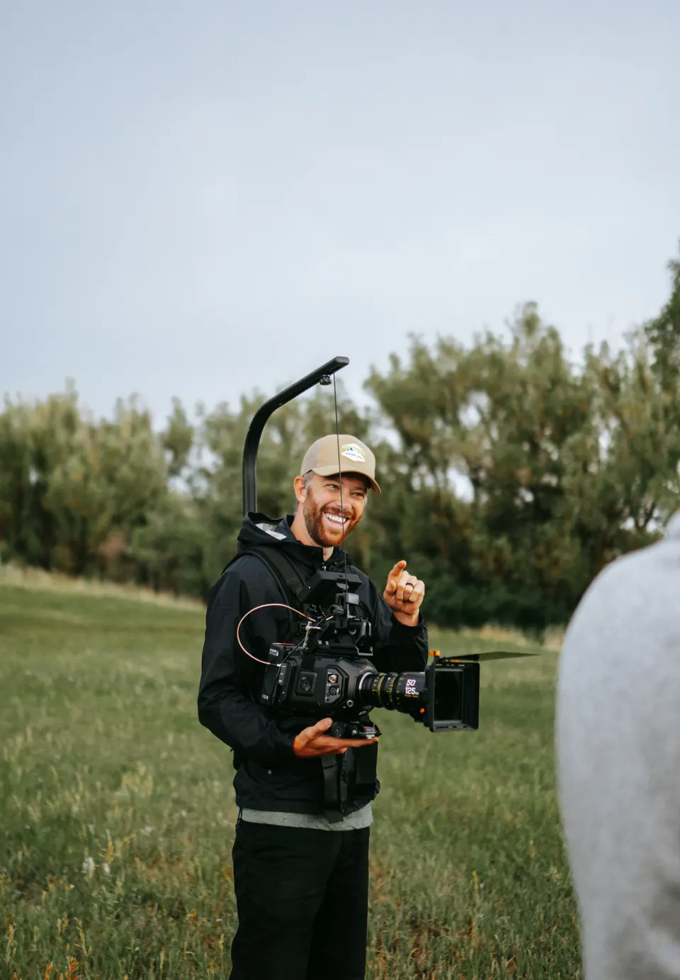 Jared Henderson filming outdoors with a cinema camera rig