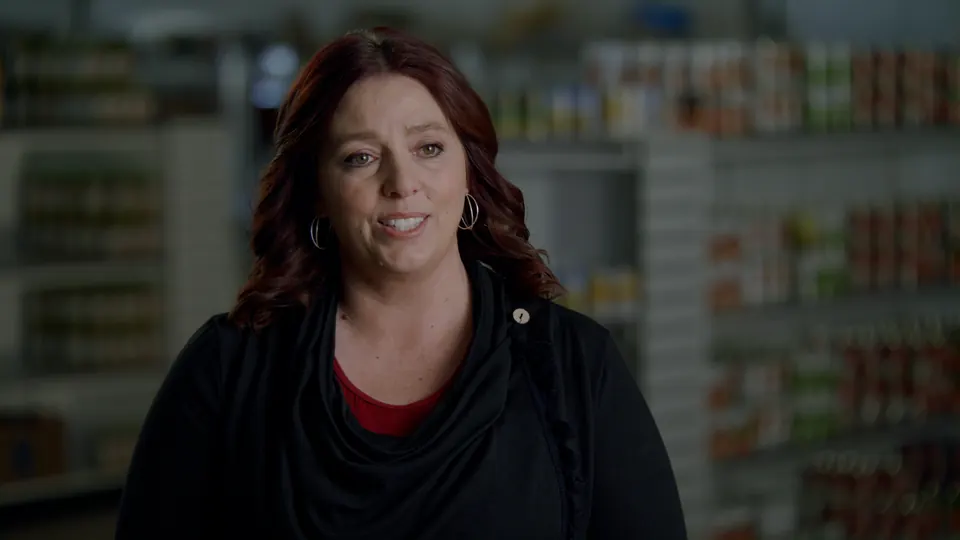 Woman interviewed among stocked shelves for Crossfire Ministries