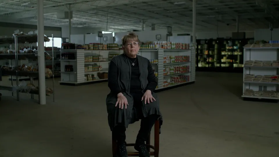 Wide shot of the man seated for his interview