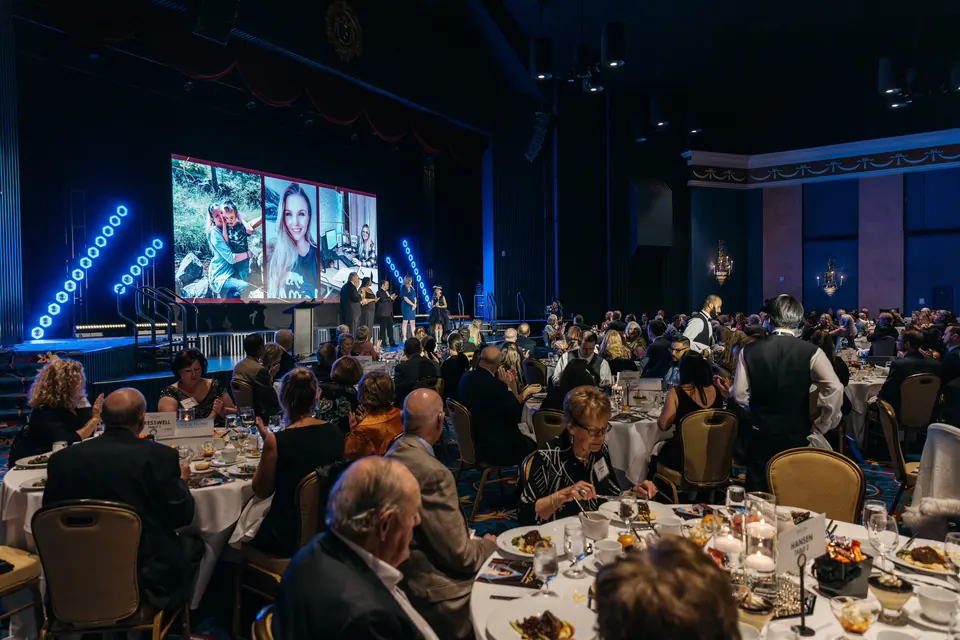 Wide view of the ballroom full of guests during the Hope & Home fashion show