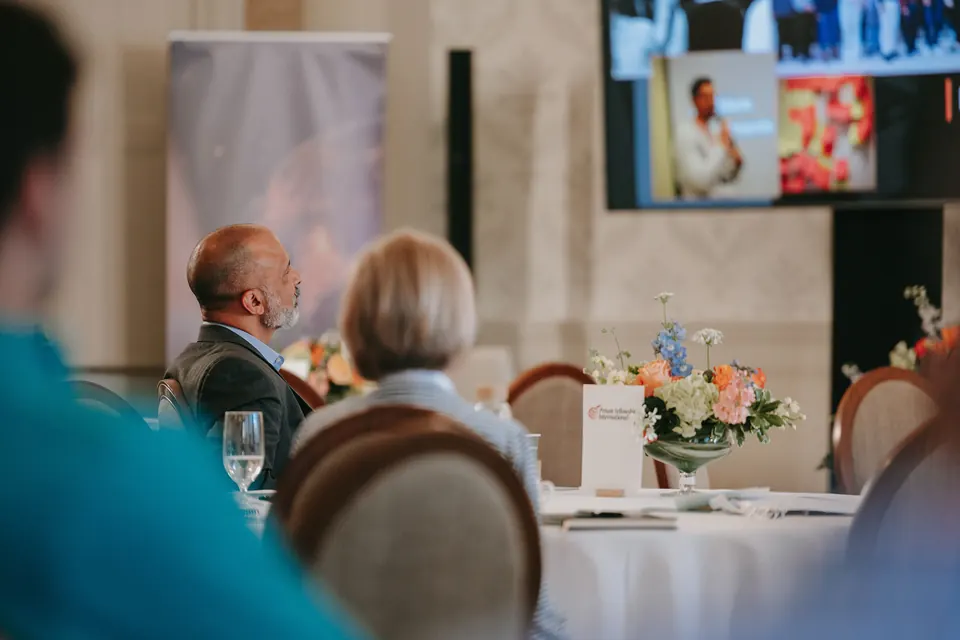 Guests at a table during a summit session